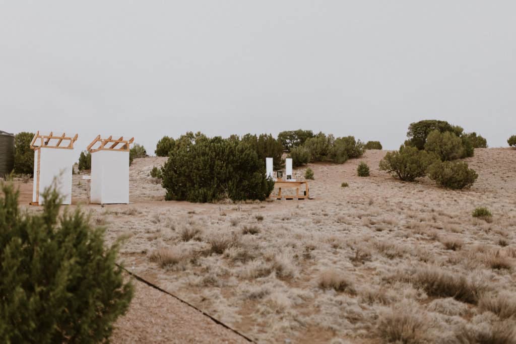 Luxury Outhouses and Washing Station in Desert Landscape at Glamping Retreat in Santa Fe New Mexico